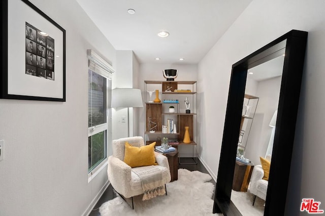 sitting room with hardwood / wood-style floors and plenty of natural light