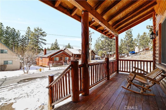 snow covered deck with covered porch