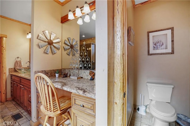 bathroom featuring toilet, vanity, and a shower