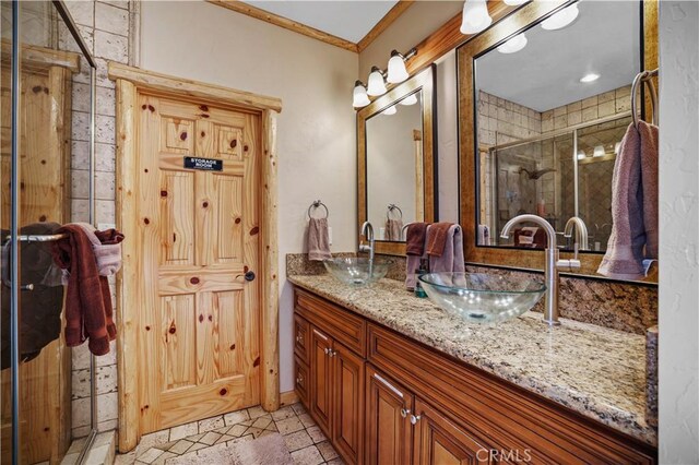 bathroom with a shower with door and vanity