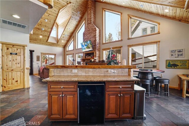 kitchen featuring wood ceiling, high vaulted ceiling, tasteful backsplash, and wine cooler