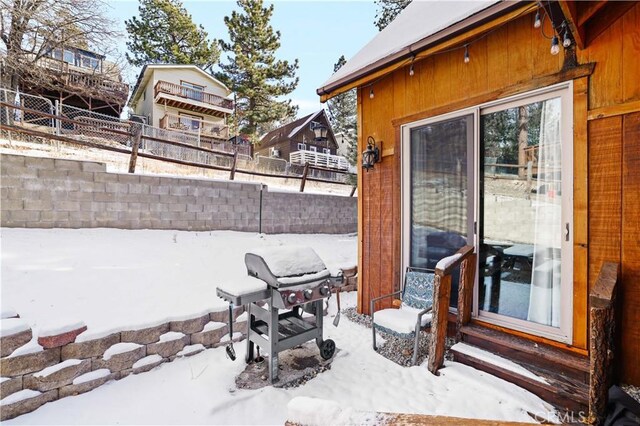 snow covered patio with area for grilling