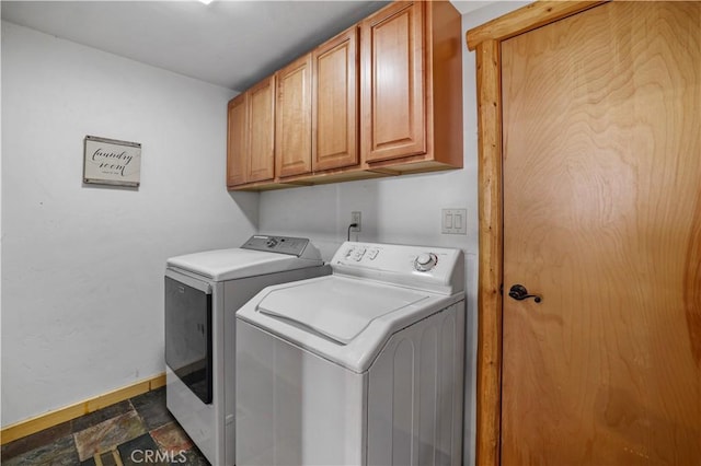 washroom with cabinets and washer and dryer