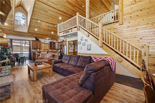 living room with high vaulted ceiling, wooden walls, wooden ceiling, and hardwood / wood-style floors