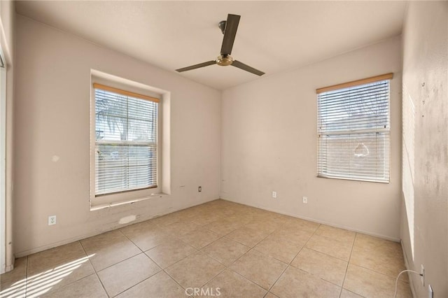 unfurnished room with ceiling fan and light tile patterned floors