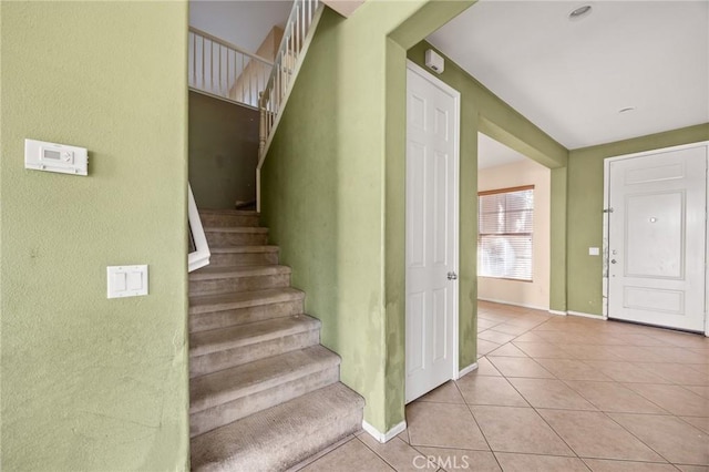 stairway featuring tile patterned floors