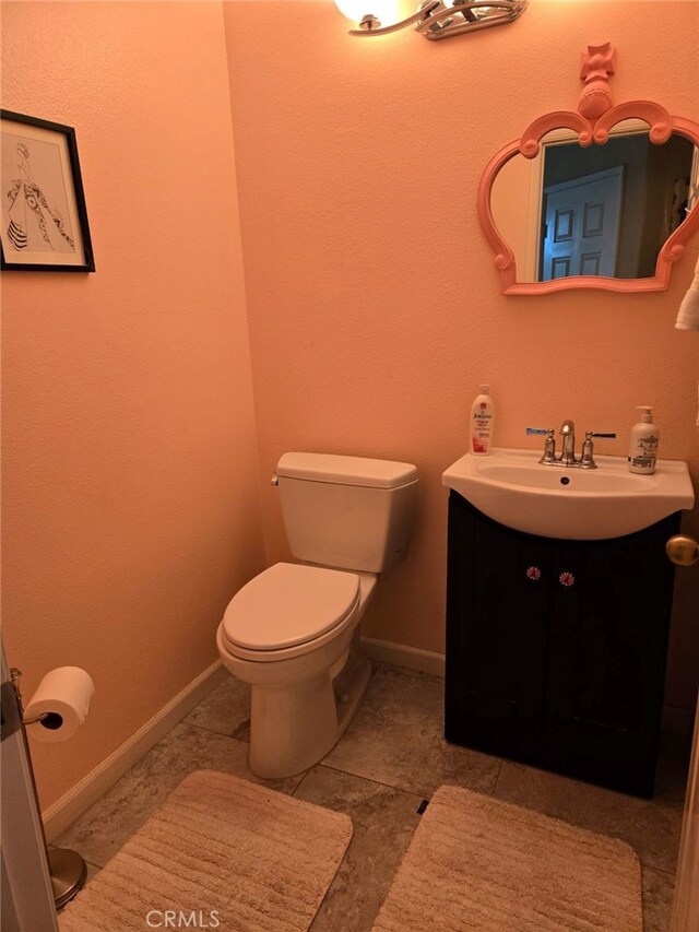 bathroom with toilet and vanity