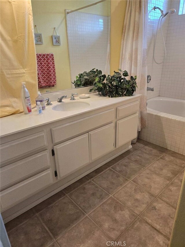 bathroom with tile patterned flooring, shower / bath combination with curtain, and vanity