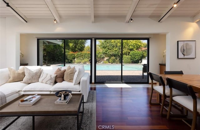 living area with dark wood-style flooring, wooden ceiling, and beam ceiling