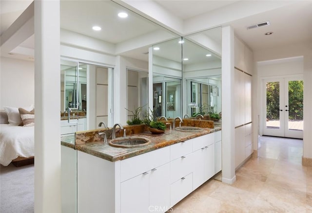 ensuite bathroom with french doors, visible vents, a sink, and ensuite bathroom