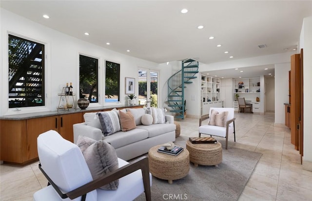 living room featuring stairway, built in features, and recessed lighting