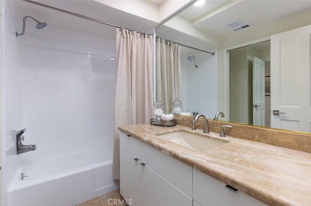 bathroom featuring vanity, shower / bath combination with curtain, and visible vents