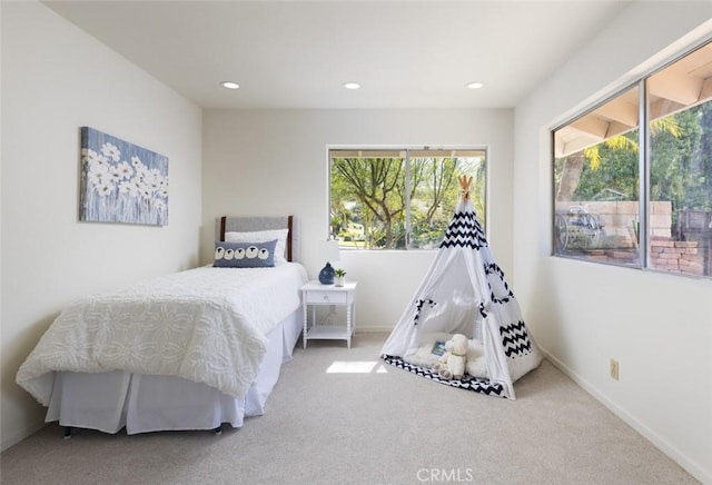 carpeted bedroom featuring recessed lighting, multiple windows, and baseboards