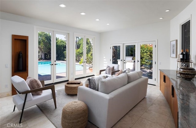 living room featuring french doors, plenty of natural light, and recessed lighting