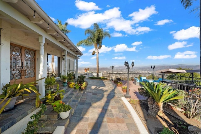 view of patio featuring french doors and a mountain view