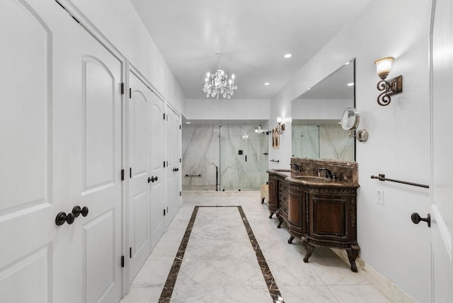 bathroom with a notable chandelier, a shower with door, and vanity