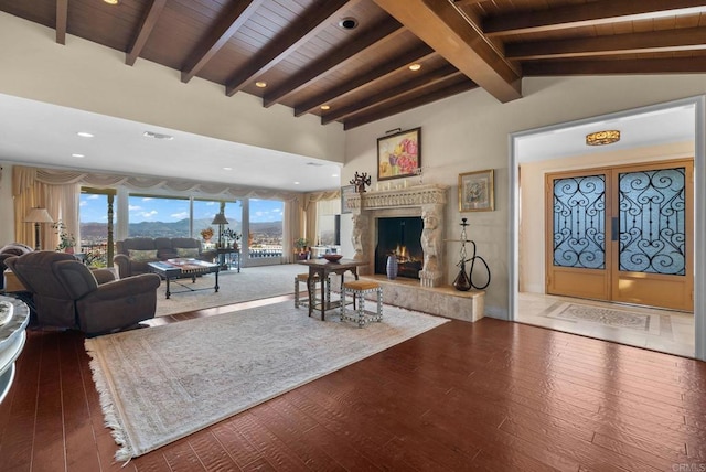 living room featuring wood-type flooring, wood ceiling, and vaulted ceiling with beams