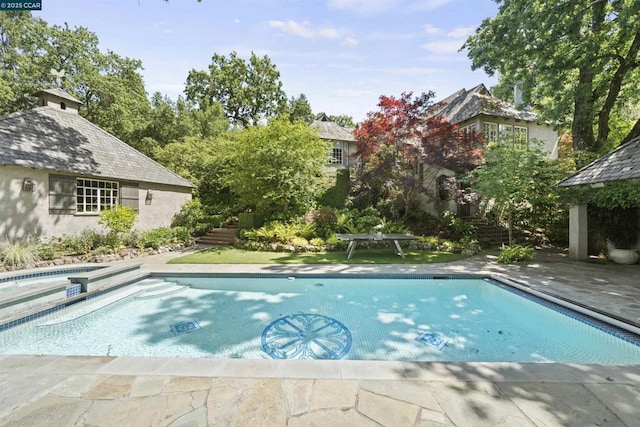 view of pool with an in ground hot tub