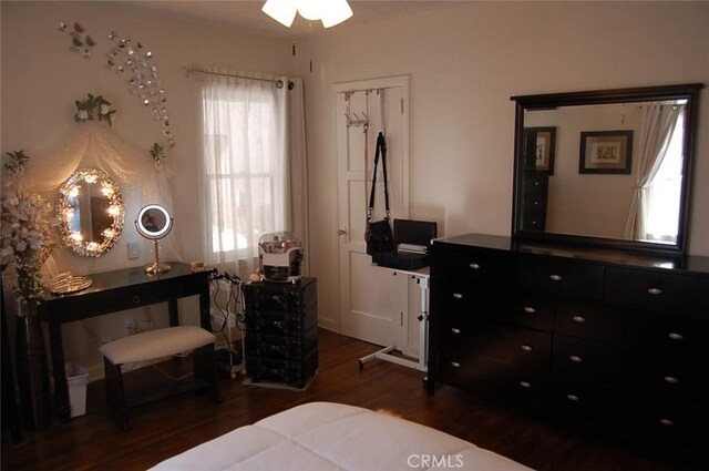 bedroom with dark wood-type flooring