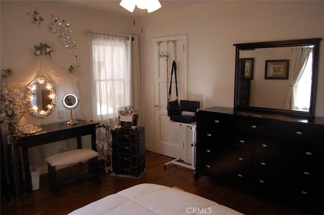 bedroom with dark hardwood / wood-style floors