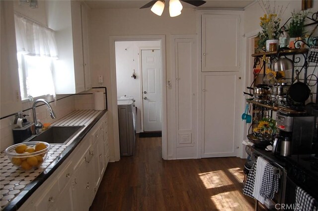 kitchen featuring white cabinets, sink, dark hardwood / wood-style floors, tile countertops, and ceiling fan