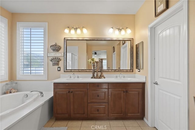 bathroom with vanity, tile patterned floors, and a bathing tub