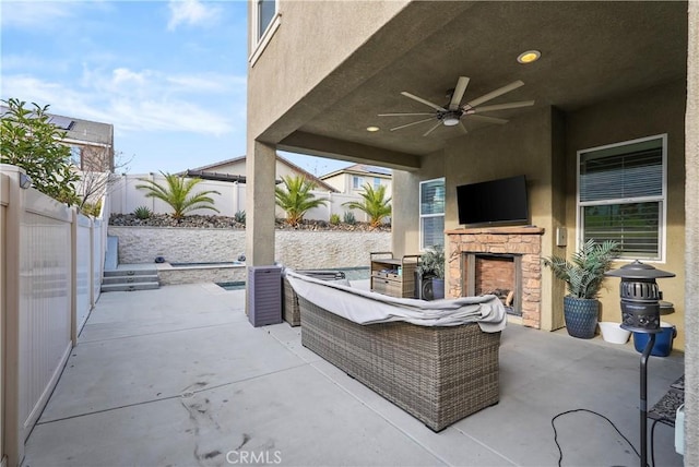 view of patio with ceiling fan and an outdoor living space