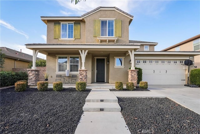 view of front of property with covered porch and a garage