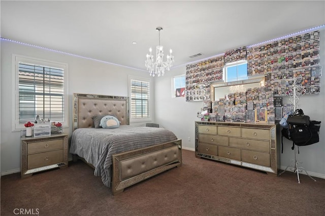 bedroom with a chandelier and dark colored carpet