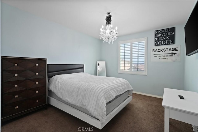 bedroom with a chandelier and dark colored carpet