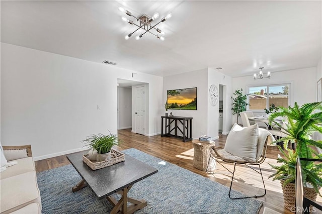 living room with a notable chandelier and hardwood / wood-style floors