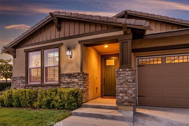 exterior entry at dusk with a garage