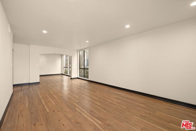 empty room with hardwood / wood-style flooring