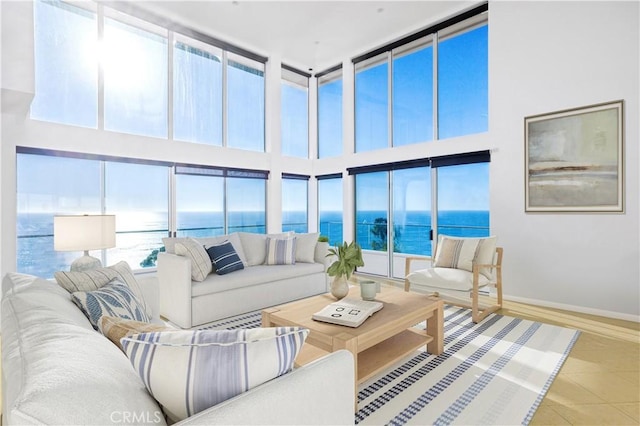 sunroom featuring a water view