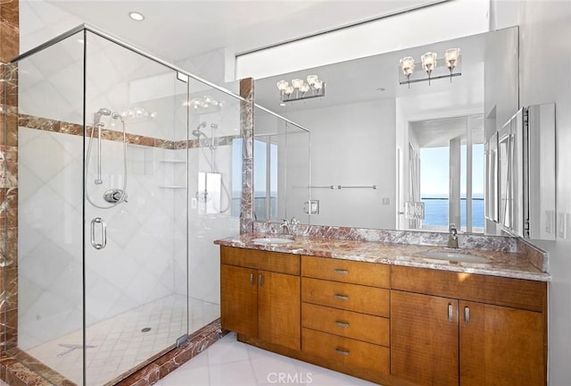 bathroom featuring vanity, a water view, an enclosed shower, and tile patterned floors