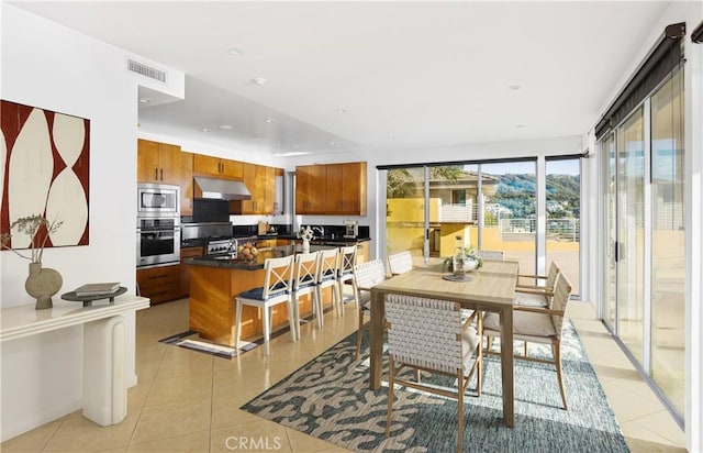 dining area featuring light tile patterned floors