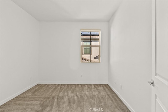 empty room with carpet flooring and baseboards