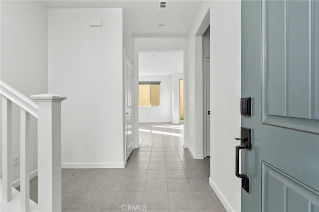 corridor with light tile patterned flooring