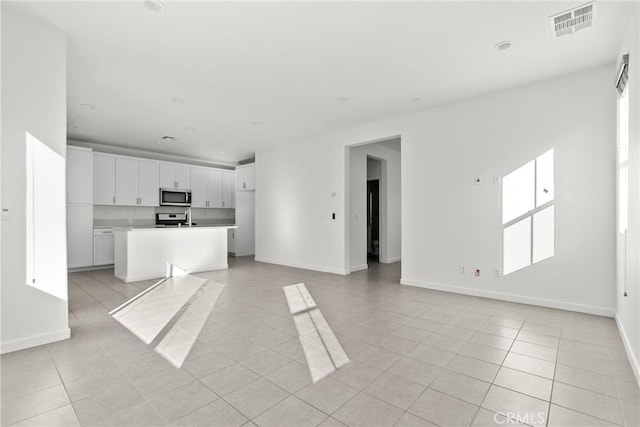 15992 Jamie Ln Unit 1, Fontana, CA 92336 - kitchen featuring appliances with stainless steel finishes, open floor plan, light tile patterned flooring, white cabinetry, and recessed lighting