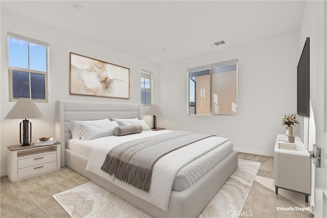 bedroom with visible vents and baseboards