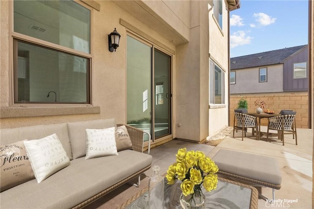 view of patio / terrace featuring outdoor dining area, outdoor lounge area, visible vents, and fence
