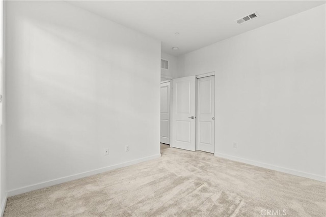 unfurnished bedroom featuring carpet floors, visible vents, and baseboards