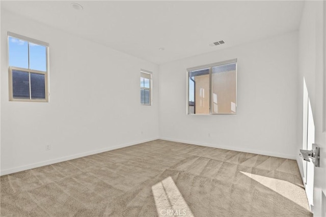 unfurnished room with light colored carpet