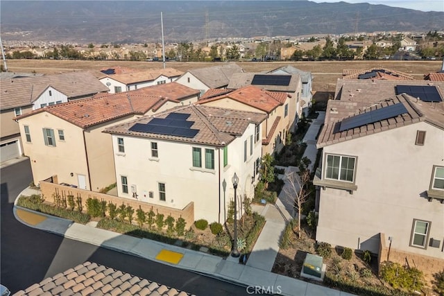 drone / aerial view featuring a residential view and a mountain view
