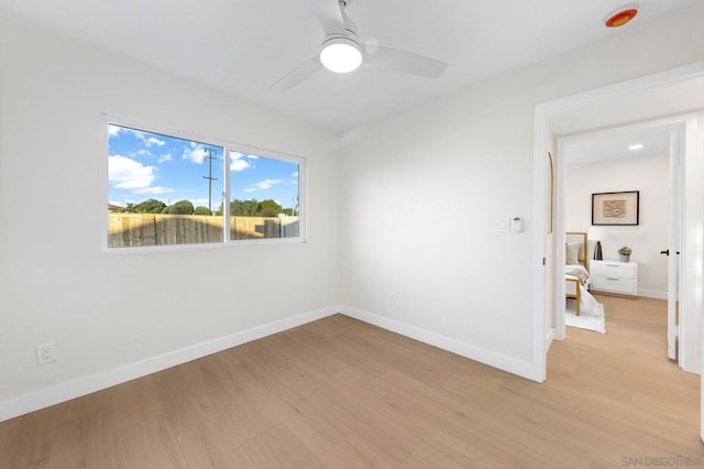 empty room featuring ceiling fan and light hardwood / wood-style floors