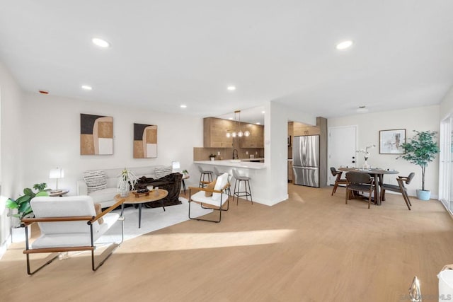 living room featuring light hardwood / wood-style floors and sink