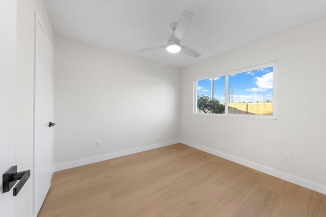 empty room with ceiling fan and light hardwood / wood-style flooring