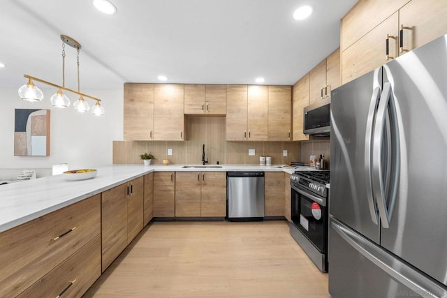 kitchen featuring light hardwood / wood-style flooring, sink, stainless steel appliances, backsplash, and light brown cabinets