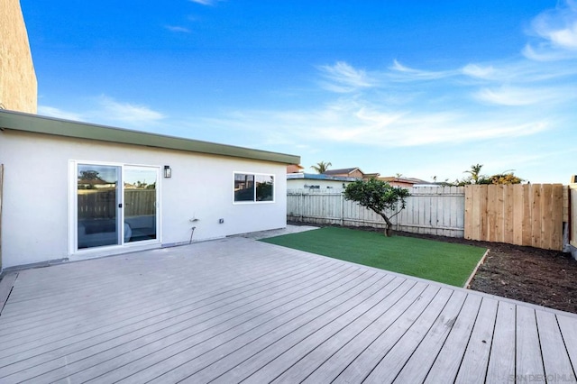 wooden terrace featuring a lawn