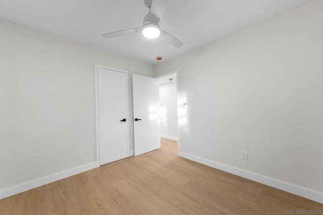 empty room featuring ceiling fan and light hardwood / wood-style flooring